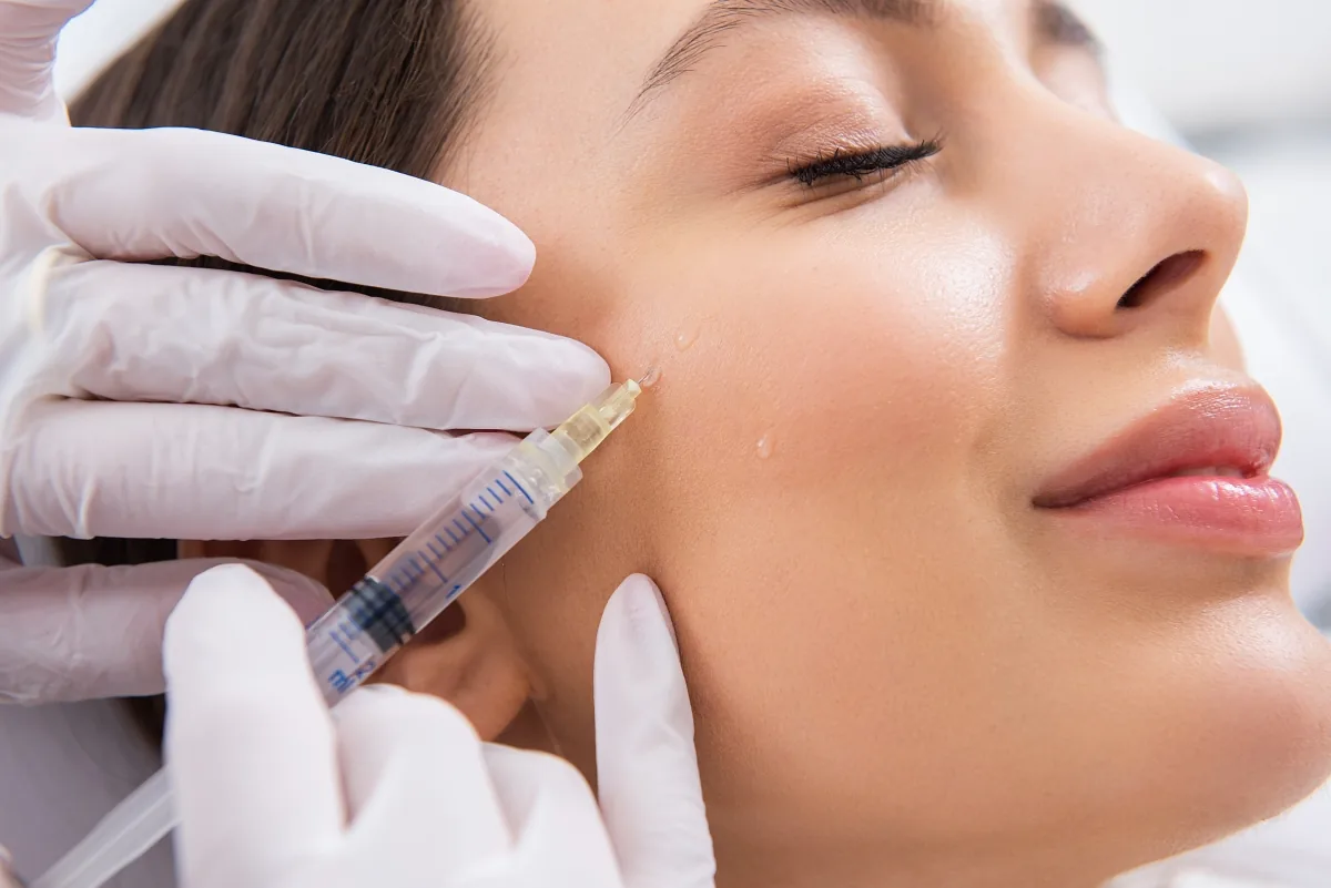 Woman happily receiving injections in her face