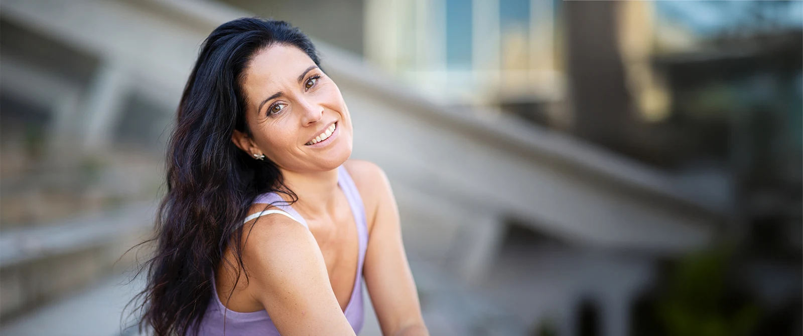 mature woman smiling with healthy hair and rejuvenated face