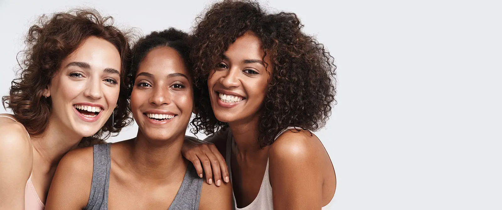 Portrait of young multiracial women standing together and smiling