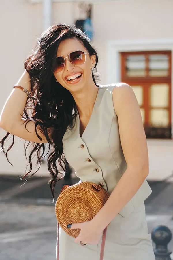 Portrait of a beautiful woman with dark long hair on a summer day in sunglasses.